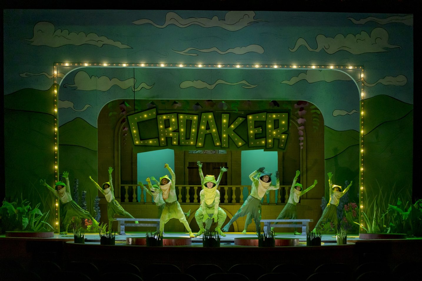 croaker sign in light up letters, actors dressed in frog costumes