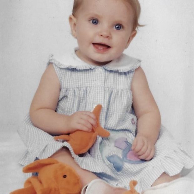 Baby photo with girl in dress with stuffed animals