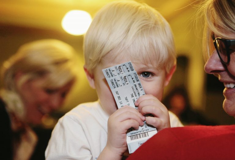 child holding ticket