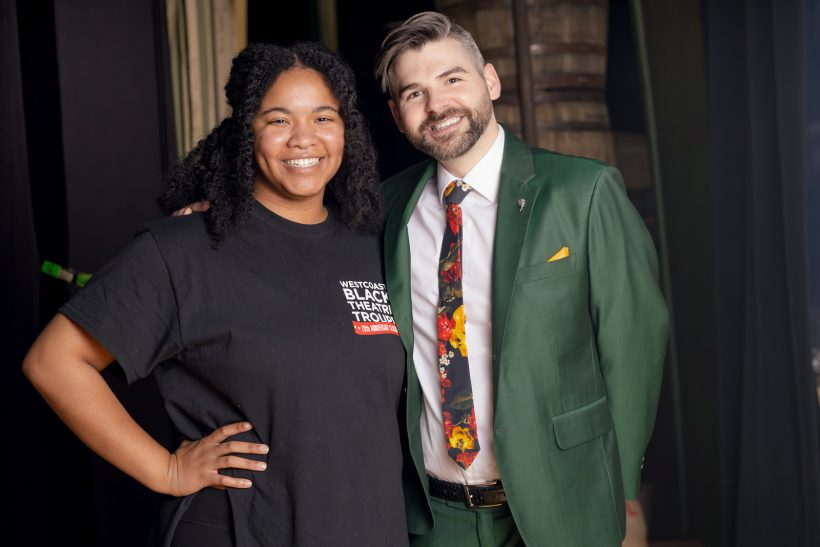 woman in black shirt with man in green suit