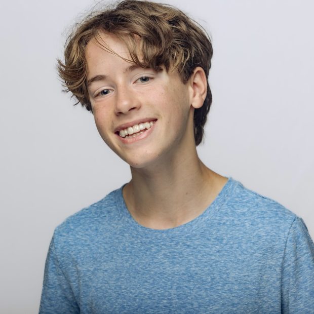 Boy with blue shirt and light grey background