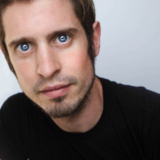 Man with blue eyes and a black shirt with a white background